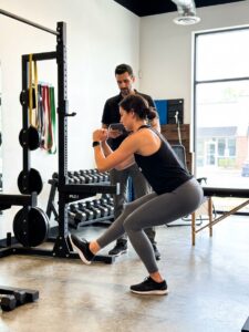 Patient working with a provider at a performance physical therapy clinic in Decatur, GA during a functional movement assessment