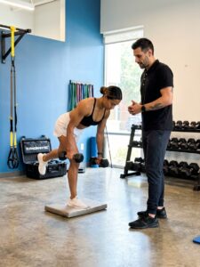 Patient working with a provider at a performance physical therapy clinic in Decatur, GA during a functional movement assessment