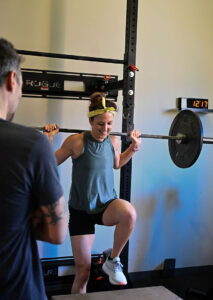  Patient working with a provider at a sports physical therapy clinic in Decatur, GA during a one-on-one manual therapy session